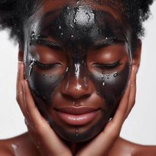 ai-generated-black-woman-applying-charcoal-face-mask-wellness-skin-care-macro-water-drops-falling-down-on-her-face-close-up-of-the-face-of-a-beautiful-african-american-woman-aesthetic-procedure-phot